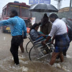 Patients being shifted from a flooded hospital after heavy rains in Chennai on Tuesday. Credit: PTI
