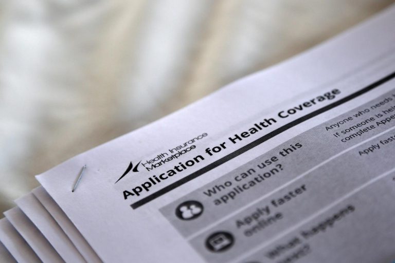 FILE PHOTO - Applications are seen at a rally held by supporters of the Affordable Care Act in Jackson Mississippi