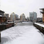 Water can be seen partially frozen over in the Limehouse Basin in London
