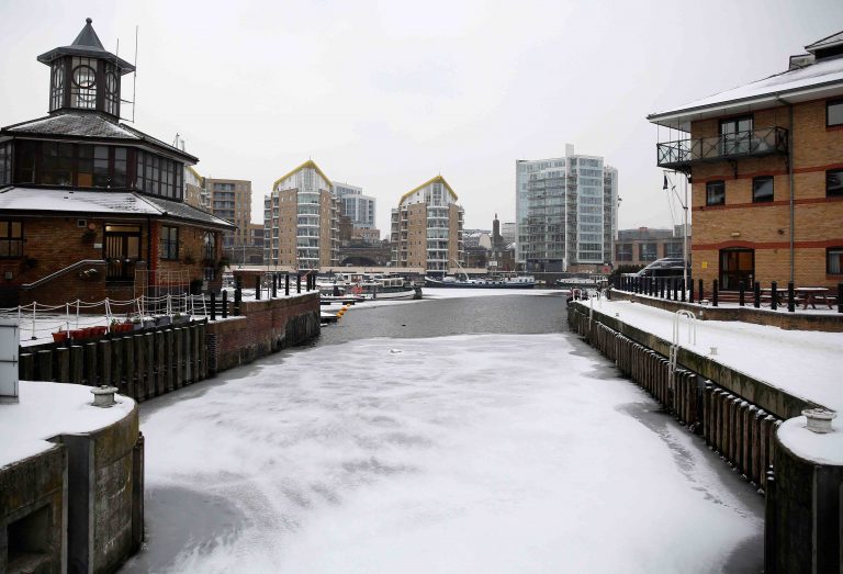 Water can be seen partially frozen over in the Limehouse Basin in London
