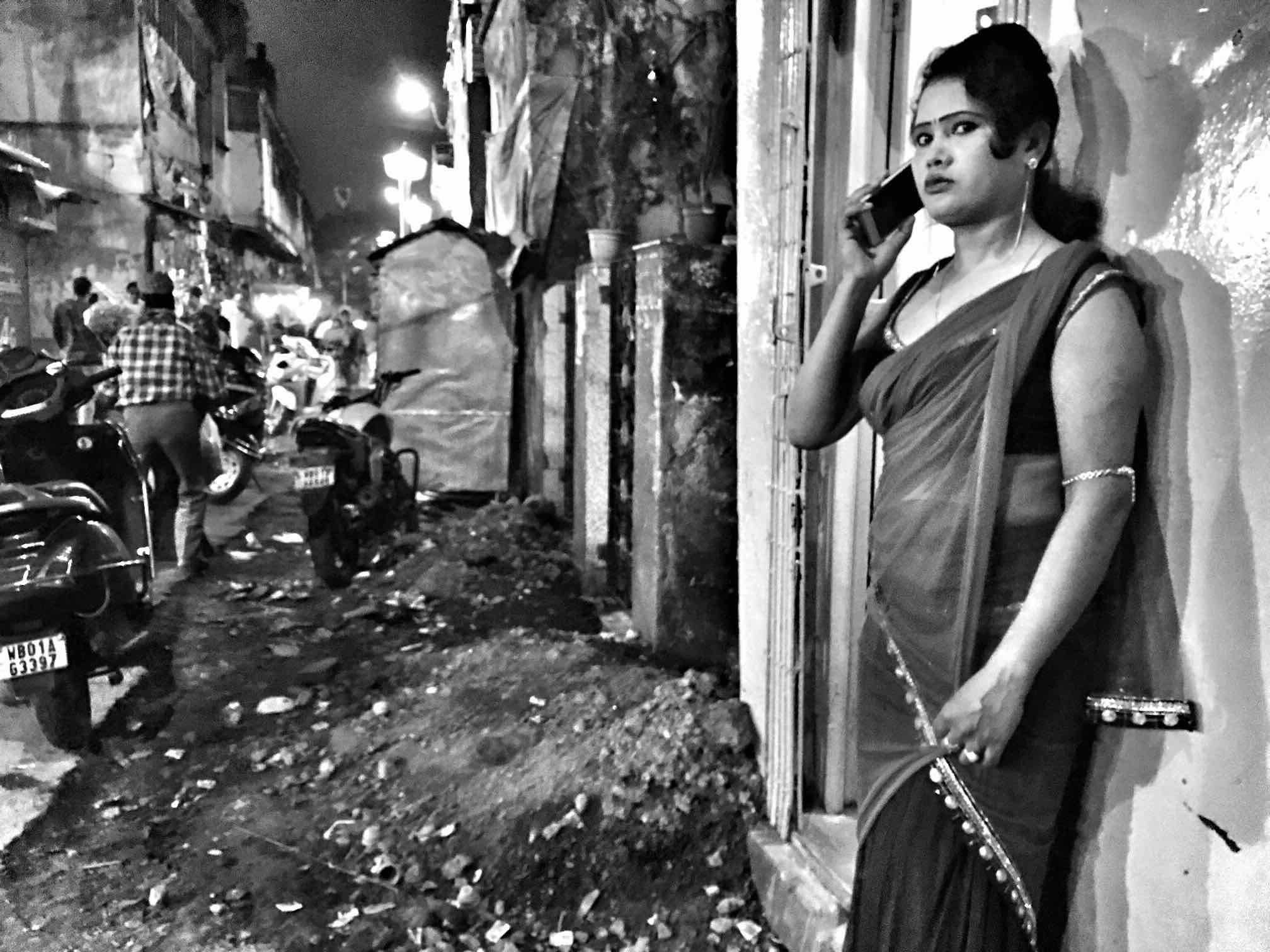 A girl waits along the by lanes of Sonagachi for clients.
