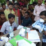 A doctor checks for tuberculosis at a health camp. Credit: cdcglobal/Flickr, CC BY 2.0