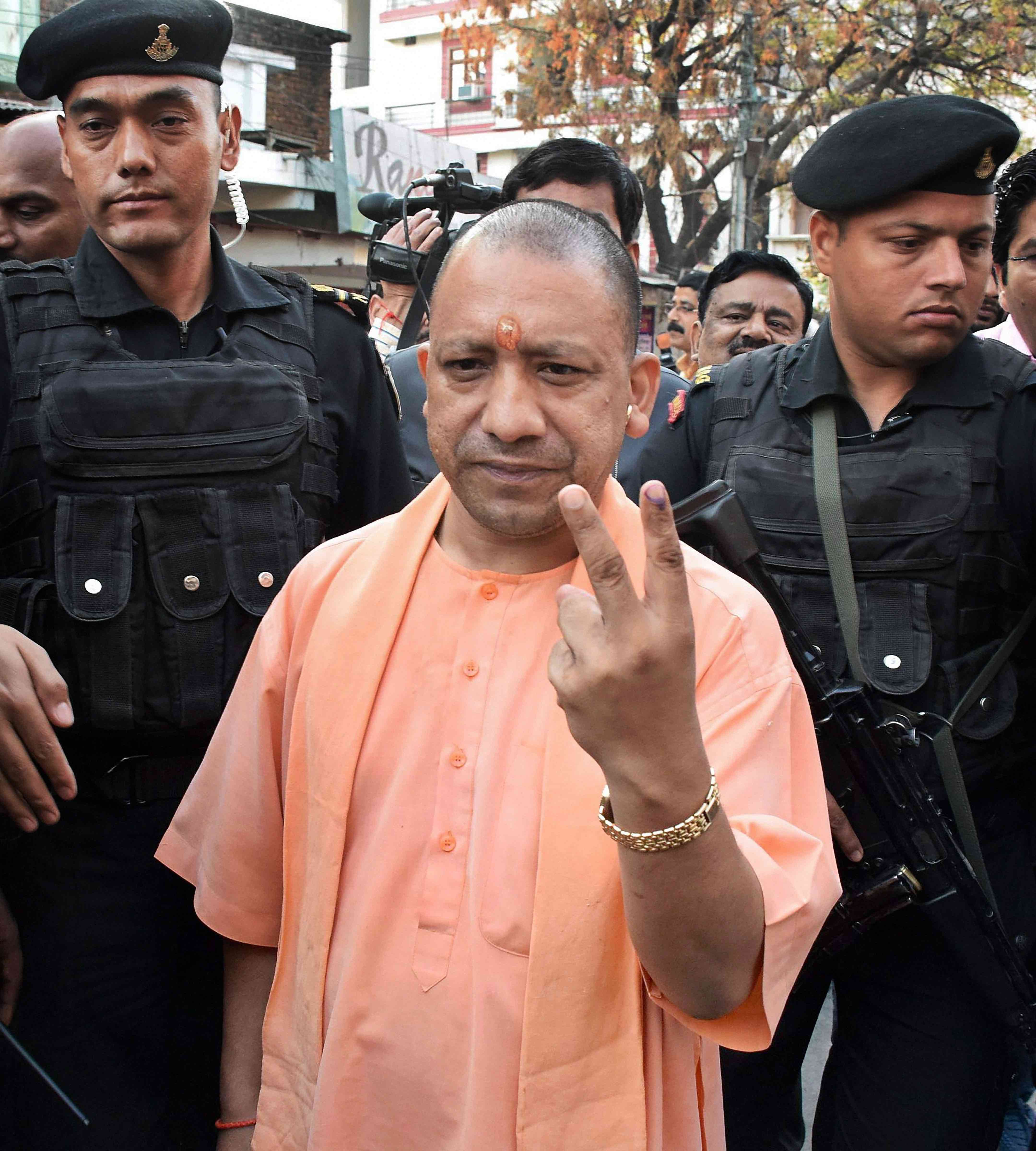 Uttar Pradesh chief minister Adityanath shows his finger marked with indelible ink after he cast his vote during Gorakhpur Lok Sabha by-poll election, in Gorakhpur on Sunday. Credit: PTI