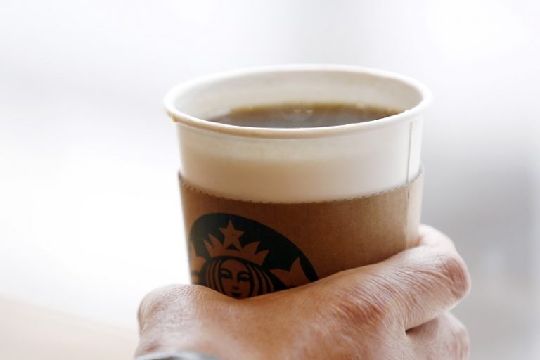 FILE PHOTO: A man holds an Americano at a Starbucks coffee shop in Seoul, South Korea, March 7, 2016. Credit: Reuters/Kim Hong-Ji