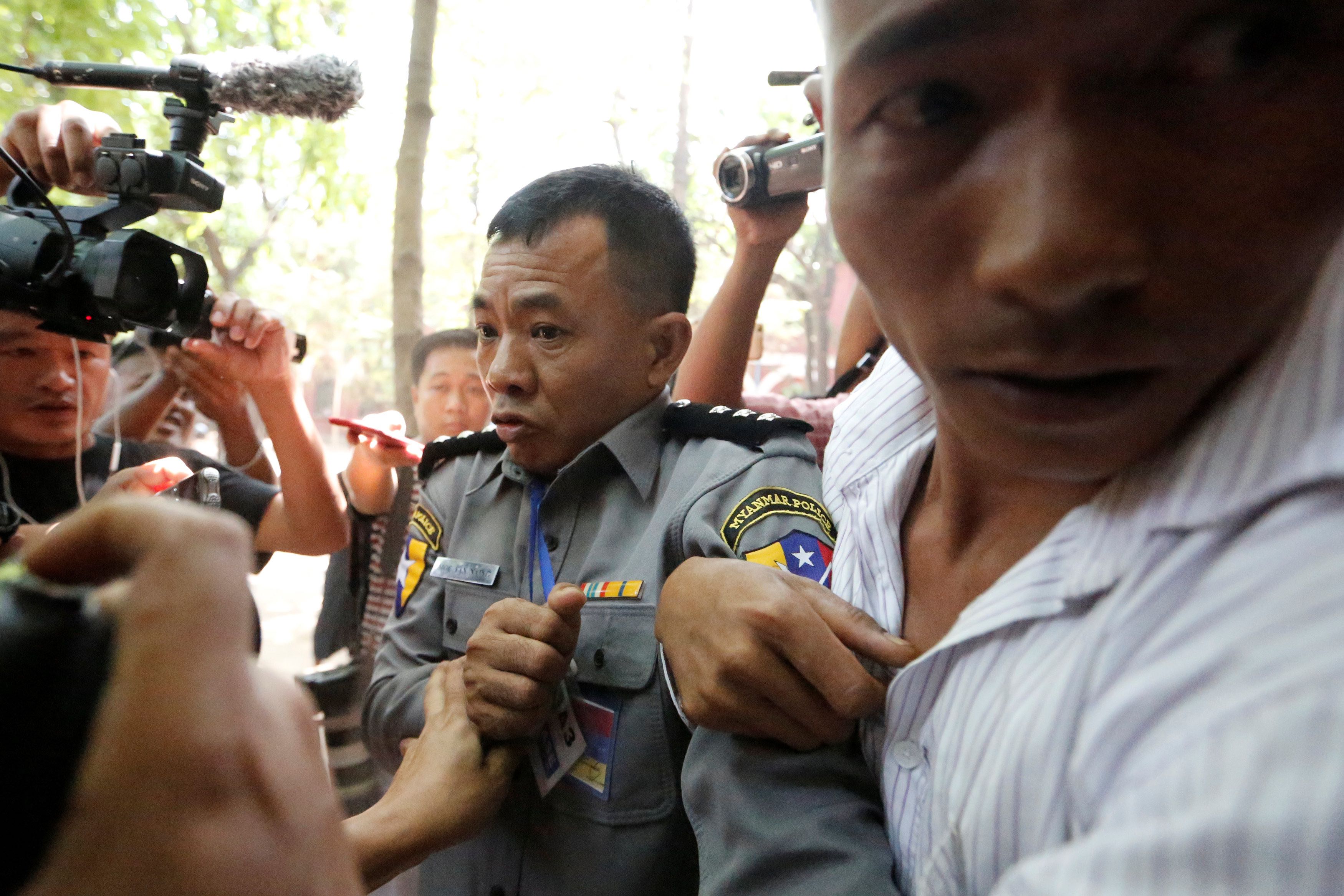 Prosecution witness police captain Moe Yan Naing walks outside the court room during a hearing of detained Reuters journalists Wa Lone and Kyaw Soe Oo in Yangon, Myanmar April 20, 2018 . Credit: Reuters/Ann Wang
