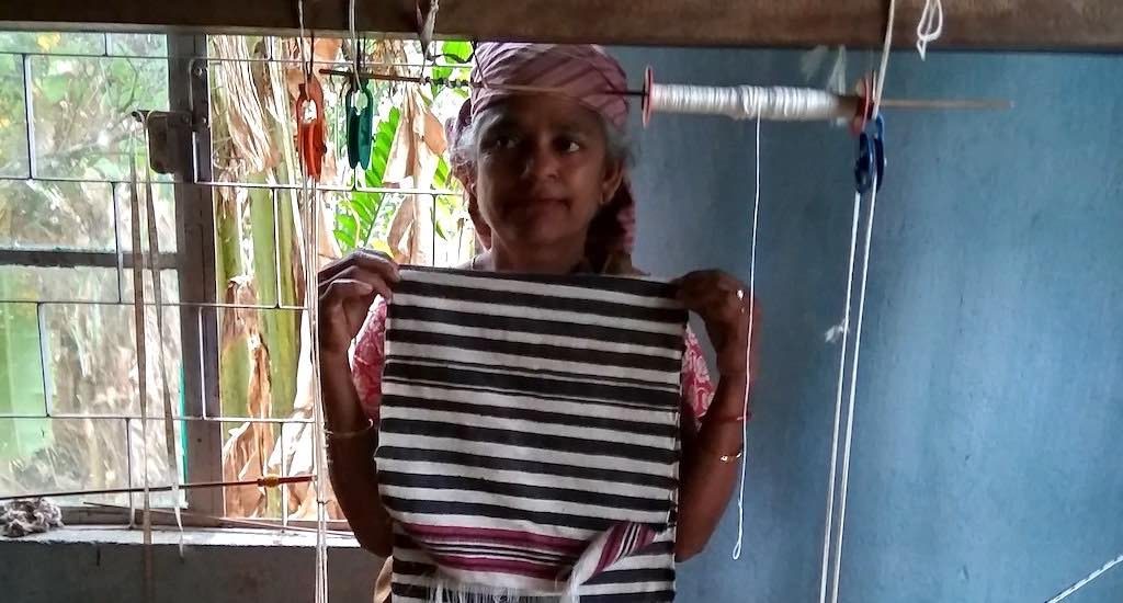 A Bhoi woman displays a just woven stole in the Diwon workshop. Credit: Linda Chhakchhuak