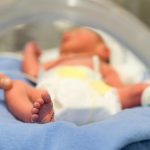 Premature baby and hand of the doctor