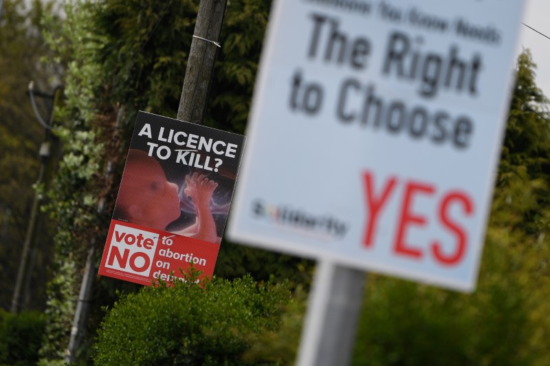 Pro-Life and Pro-Choice posters are seen outside the home of Amy Callahan who received a fatal foetal diagnosis at 12 weeks into her pregnancy and travelled to Liverpool for a termination in Dublin, Ireland, May 7, 2018. Picture taken May 7, 2018. Credit: Reuters/Clodagh Kilcoyne