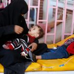 A woman sits with her sons while they are treated at a cholera treatment center in Sanaa, Yemen October 8, 2017. Picture taken October 8, 2017. Credit: Reuters/Khaled Abdullah/Files