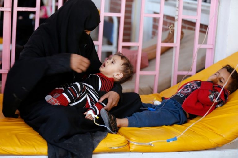 A woman sits with her sons while they are treated at a cholera treatment center in Sanaa, Yemen October 8, 2017. Picture taken October 8, 2017. Credit: Reuters/Khaled Abdullah/Files