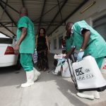 FILE PHOTO: A health worker sprays a colleague with disinfectant during a training session for Congolese health workers to deal with Ebola virus in Kinshasa October 21, 2014. Credit: Reuters/Media Coulibaly/File Photo