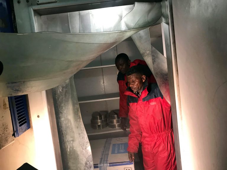 The first batch of 4,000 experimental Ebola vaccines to combat an outbreak is loaded into a fridge as it arrives at the airport in Kinshasa