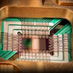 Photograph of a chip constructed by D-Wave Systems Inc. designed to operate as a 128-qubit superconducting adiabatic quantum optimization processor, mounted in a sample holder. Caption and credit: D-Wave Systems, Inc./Wikimedia Commons, CC BY 3.0