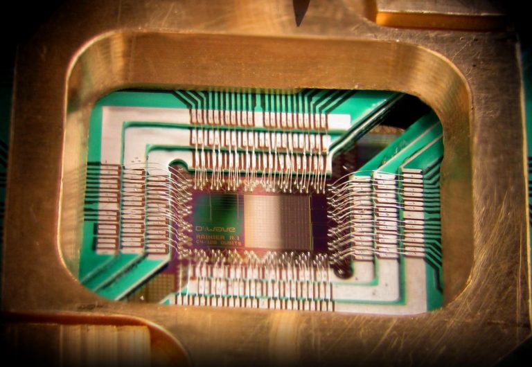 Photograph of a chip constructed by D-Wave Systems Inc. designed to operate as a 128-qubit superconducting adiabatic quantum optimization processor, mounted in a sample holder. Caption and credit: D-Wave Systems, Inc./Wikimedia Commons, CC BY 3.0