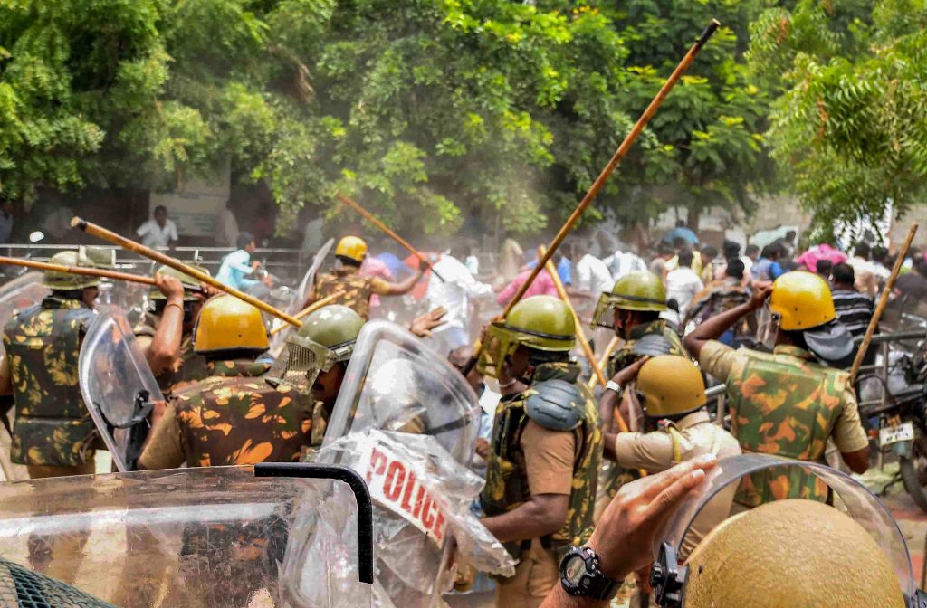 Police personnel baton charge at protestors who were demanding the closure of Vedanta's Sterlite Copper unit, in Tuticorin, on Wednesday. Credit: PTI