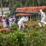 Kozhikode: Relatives and hospital officals wear safety masks as they perform the last rites of V Moosa (61), a 'Nipah' virus victim, at Kannam Parambu graveyard, in Kozhikode, on Thursday. The death toll due to Nipah rose to 11 in Kerala. Moosa's sons Mohammed Saliah (28), Mohammed Sadiq (26) and a relative Mariumma had died earlier due to the deadly virus. Credits: (PTI Photo) (story no MDS2)(PTI5_24_2018_000148B)