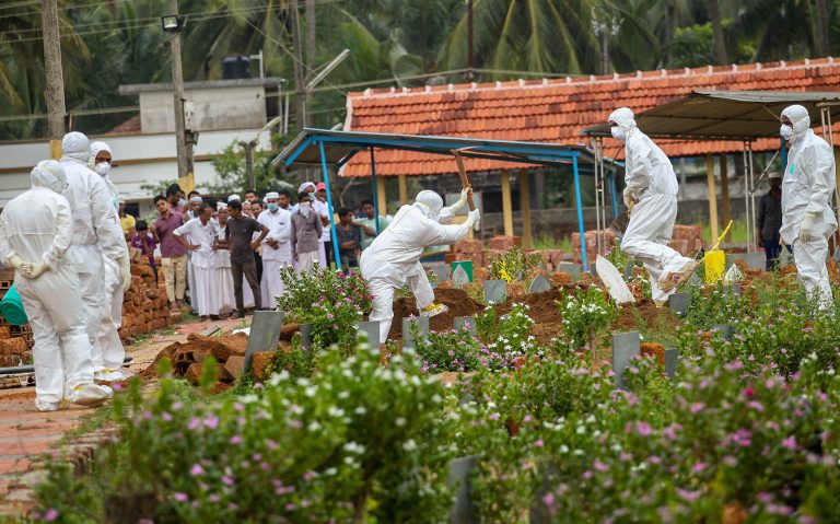 Kozhikode: Relatives and hospital officals wear safety masks as they perform the last rites of V Moosa (61), a 'Nipah' virus victim, at Kannam Parambu graveyard, in Kozhikode, on Thursday. The death toll due to Nipah rose to 11 in Kerala. Moosa's sons Mohammed Saliah (28), Mohammed Sadiq (26) and a relative Mariumma had died earlier due to the deadly virus. Credits: (PTI Photo) (story no MDS2)(PTI5_24_2018_000148B)