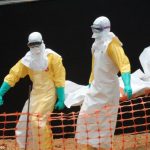 Staff of the 'Doctors without Borders' ('Medecin sans frontieres') carry the body of a person killed by viral haemorrhagic fever, at a center for victims of the Ebola