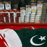 Brands of cigarette packs with health warning are displayed in the showcase of a kiosk painted with Pakistan's national flag, along a road in Karachi, Pakistan May 5, 2018. Credit: Reuters/Akhtar Soomro/Files