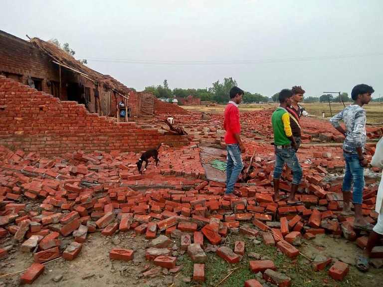 Villagers inspect the damaged house which collapsed during last night's thunderstorm and rain, in Unnao, Uttar Pradesh on Tuesday, May 29, 2018. As many as five persons were killed and four others injured as lightning struck some parts of Unnao district. Credit: PTI