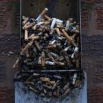 Used cigarette butts spill out of a full ashtray on the wall of a shopping centre in Warrington, northern England January 15, 2013. Credit: Reuters/Phil Noble