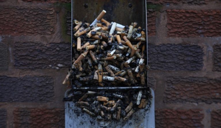 Used cigarette butts spill out of a full ashtray on the wall of a shopping centre in Warrington, northern England January 15, 2013. Credit: Reuters/Phil Noble