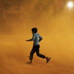 A boy runs for cover during a dust storm in New Delhi, India May 13, 2018. Credit: Reuters/Adnan Abidi