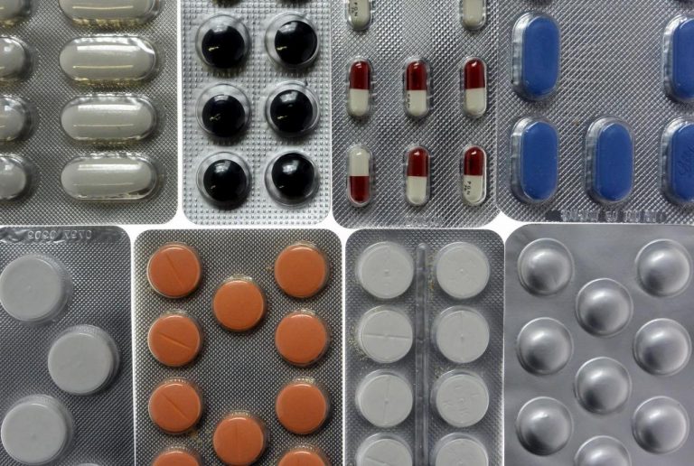 File photo illustration shot in Ljubljana of pharmaceutical tablets and capsules in foil strips