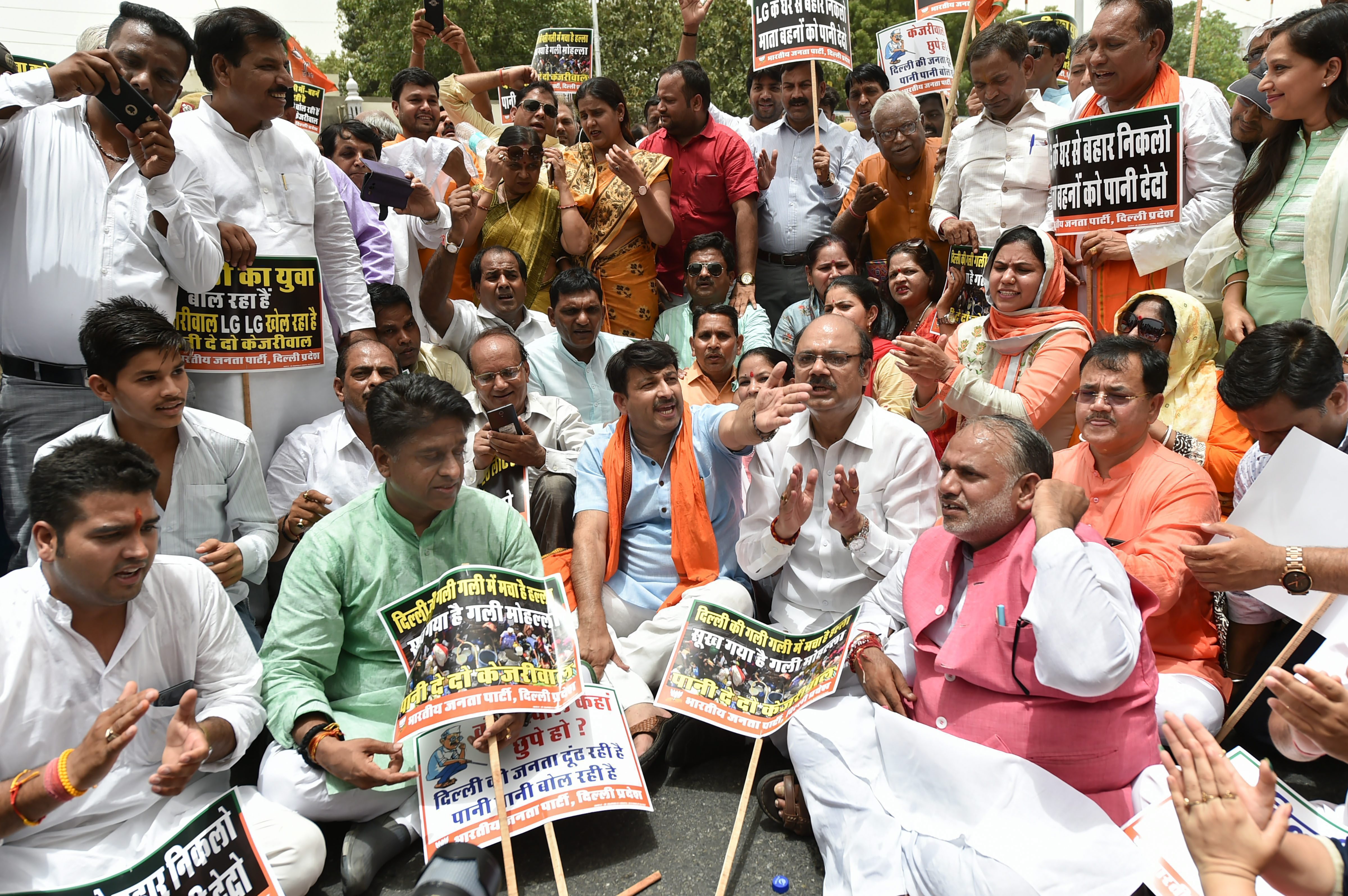 Delhi BJP president Manoj Tiwari with party workers raise slogans demanding water-power supply as they march towards Delhi chief minister Arvind Kejriwal's office, in New Delhi on Wednesday, June 13, 2018. Credit: PTI/Arun Sharma