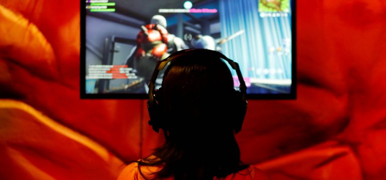 FILE PHOTO: An attendee plays a video game at E3, the world's largest video game industry convention in Los Angeles