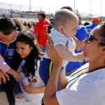 Marcelino Pizarro greets his daughter, Denisse, and for the first time granddaughter Aitana, as his daughter, Fatima Paola, holds her baby brother, Matias, during a greeting for family members from both sides of the border during the "Hugs not Walls" event on the border of Juarez, Mexico, and El Paso, Texas, US, May 12, 2018. Reuters File Photo