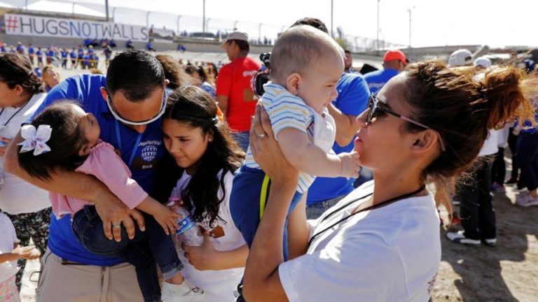 Marcelino Pizarro greets his daughter, Denisse, and for the first time granddaughter Aitana, as his daughter, Fatima Paola, holds her baby brother, Matias, during a greeting for family members from both sides of the border during the "Hugs not Walls" event on the border of Juarez, Mexico, and El Paso, Texas, US, May 12, 2018. Reuters File Photo