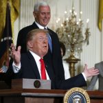 US President Donald Trump reacts next to Vice President Mike Pence after signing a national space policy directive during a meeting of the National Space Council in the East Room of the White House in Washington, US, June 18, 2018. Credit: Reuters/Leah Millis