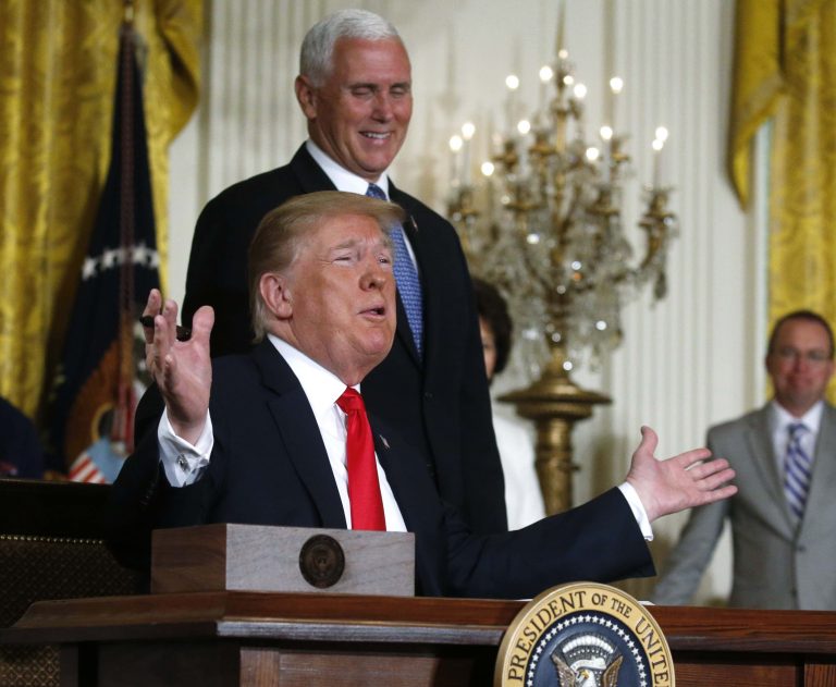 US President Donald Trump reacts next to Vice President Mike Pence after signing a national space policy directive during a meeting of the National Space Council in the East Room of the White House in Washington, US, June 18, 2018. Credit: Reuters/Leah Millis
