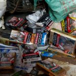 Cigarette packets with graphic pictorial warnings are pictured on the counter of a cigarette seller in Mumbai