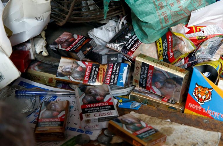 Cigarette packets with graphic pictorial warnings are pictured on the counter of a cigarette seller in Mumbai