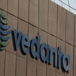 A bird flies past the logo of Vedanta installed on the facade of its headquarters in Mumbai