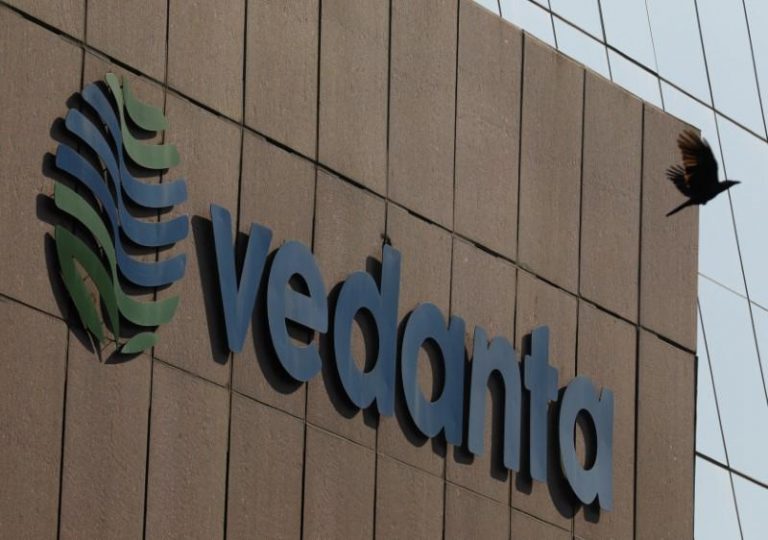 A bird flies past the logo of Vedanta installed on the facade of its headquarters in Mumbai