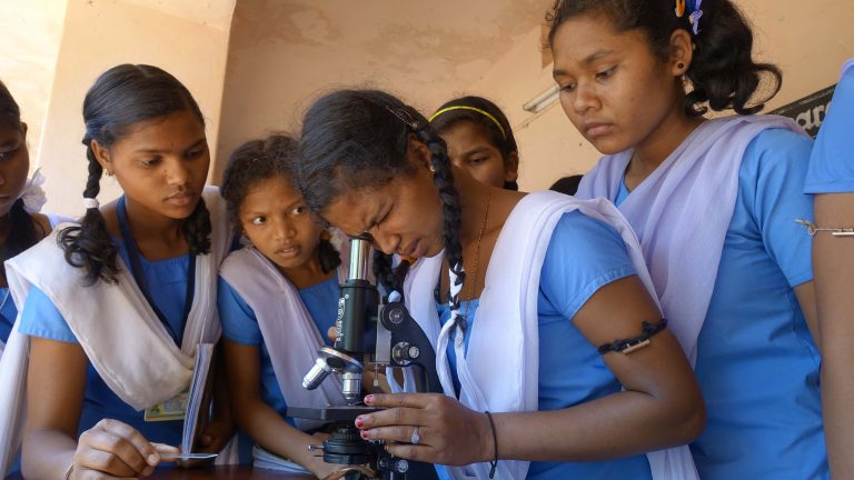 Students_of_Hata_Muniguda_school_seeing_through_a_microscope