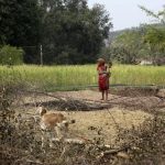 A young girl holds an infant in Amelia village in Singrauli district in the central Indian state of Madhya Pradesh