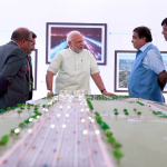 Narendra Modi visiting the exhibition to review progress of Delhi-Meerut Expressway, in Delhi. Union Minister for Road Transport Nitin Gadkari and MoS for Road Transport & Highways, Mansukh Mandviya are also seen. Credit: Twitter/MIB_India