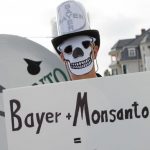 Activists protest against the acquisition of the U.S. agrochemical company Monsanto by the German Bayer company in Bonn, Germany, Friday, May 25, 2018. Credit: Reuters