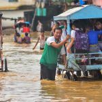 People wading through flood waters in Nagaland. Credits: PTI