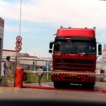 Workers in protective suits are seen by a truck at a Shuanghui plant following a discovery of pigs infected by the African swine fever (ASF), in Zhengzhou