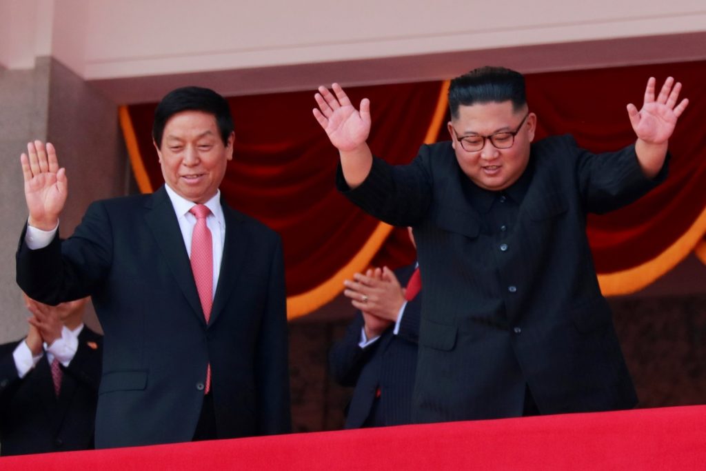 North Korean leader Kim Jong Un and China's Li Zhanshu, chairman of the Standing Committee of the National People's Congress (NPC), wave while attending a military parade marking the 70th anniversary of North Korea's foundation in Pyongyang, North Korea, September 9, 2018. Credits: Reuters/Danish Siddiqui