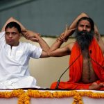 Yoga guru Baba Ramdev and Managing Director ofPatanjali Ayurved Acharya Balkrishna perform yoga during a four-day long camp ahead of International Yoga day, in Ahmedabad