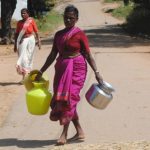 Women return disappointed with empty pots after the only borewell is shut after the pump overheats at Peddarpally village. Credit: Meena Menon.