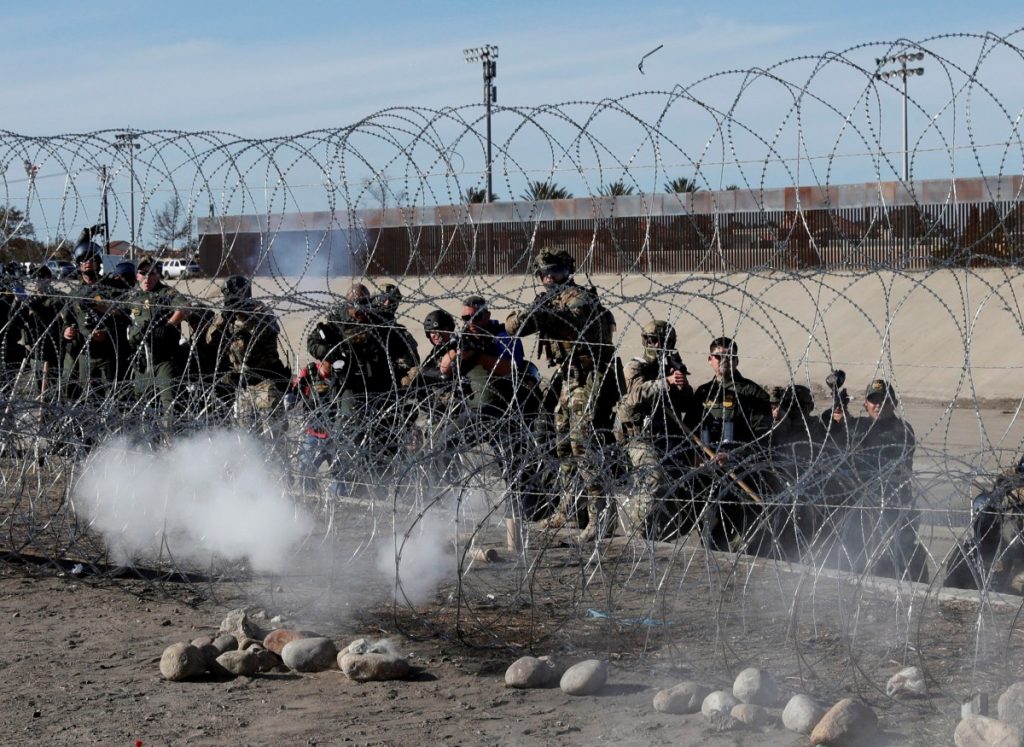 U.S. soldiers and U.S. border patrols fire tear gas towards migrants, part of a caravan of thousands traveling from Central America en route to the United States, from the U.S.side of the border fence between Mexico and the United States in Tijuana, Mexico, November 25, 2018. Credit: REUTERS/Kim Kyung-Hoon