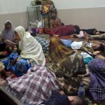 Residents sit inside a mosque as they evacuated following high waves and the eruption of Anak Krakatau volcano at Labuan district in Pandeglang regency, Banten province, Indonesia, December 22, 2018 in this photo taken by Antara Foto. Picture taken December 22, 2018. Credit: Antara Foto/Muhammad Bagus Khoirunas/ via REUTERS