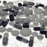 Pharmaceutical tablets and capsules are arranged on table in photo illustration